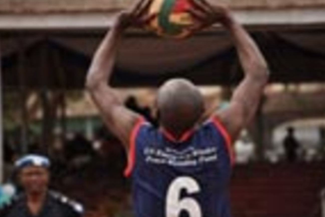 Playing the game, police and military personnel give volleyball their best shot in the qualifying games of the regional tournament.